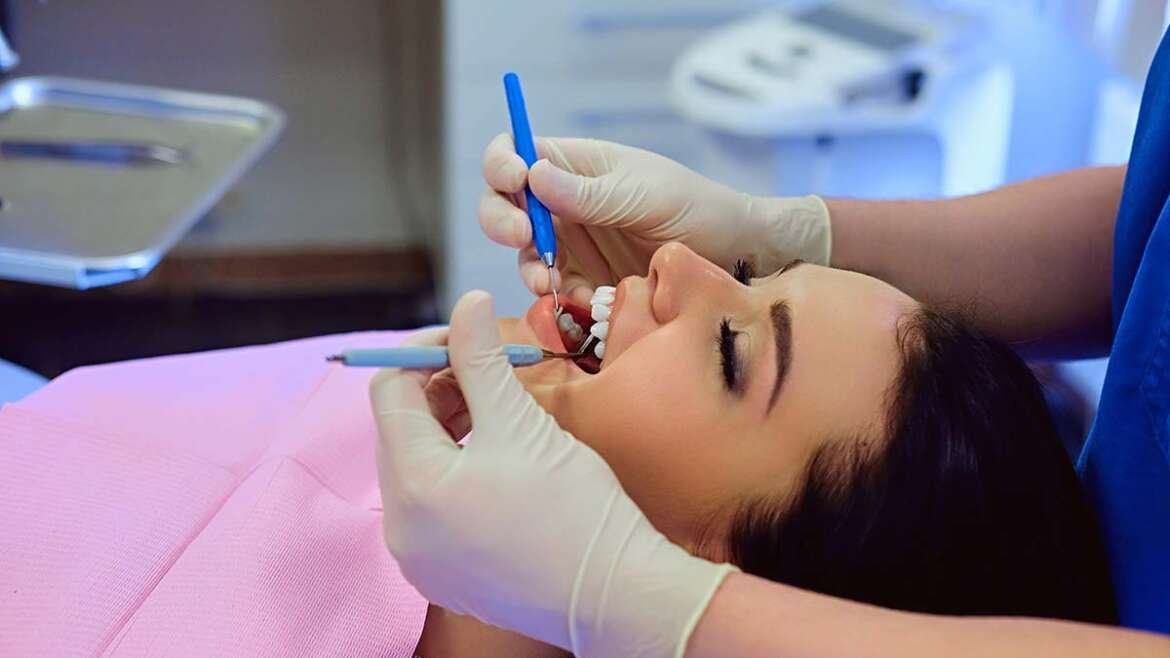 Dentist performing preventive dental checkup during routine professional teeth examination