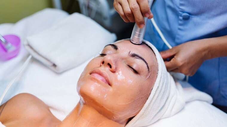 Woman receiving professional skin treatment during a clinical facial procedure.