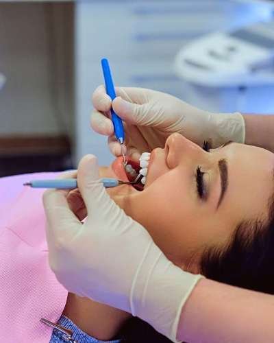 Dentist performing preventive dental checkup during routine professional teeth examination